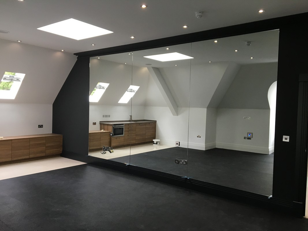 Frameless glass wall dividing loft conversion in Shepherd's Bush