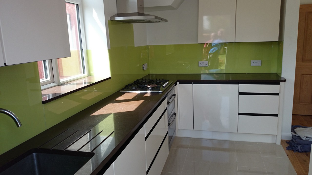 Lime green glass kitchen splashback installed by Shepherd's Bush glaziers