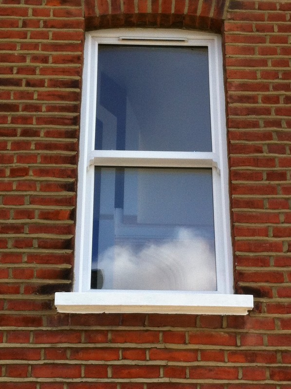 uPVC sash window on Victorian red brick house in Shepherd's Bush
